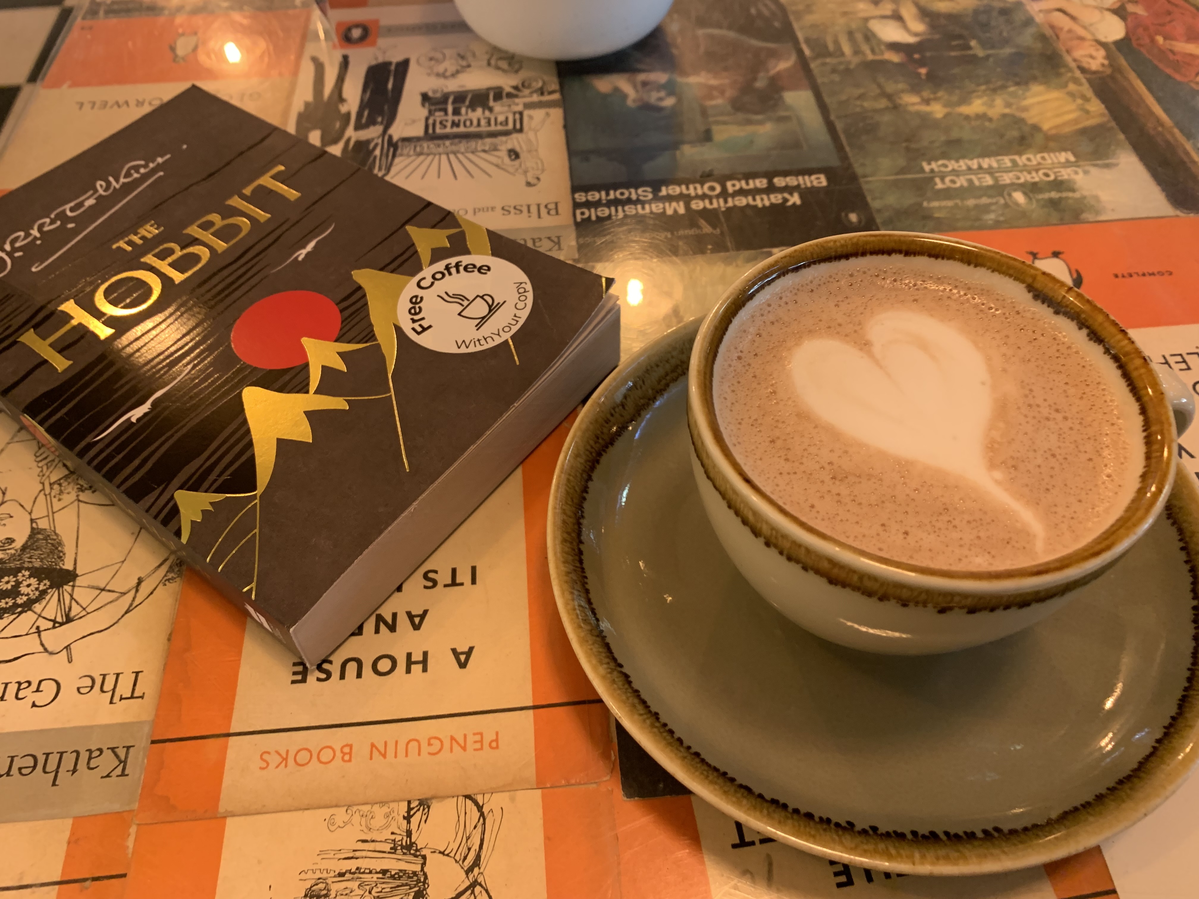 A copy of The Hobbit and a hot chocolate